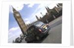 Taxi on road with big ben in background, London by Assaf Frank